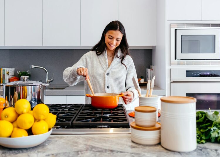 woman cooking inside kitchen room