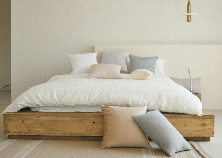 white bed pillow on brown wooden bed frame